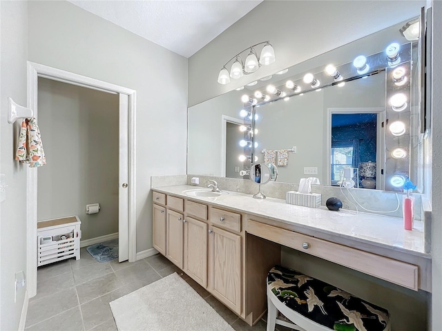 bathroom featuring tile patterned flooring and vanity