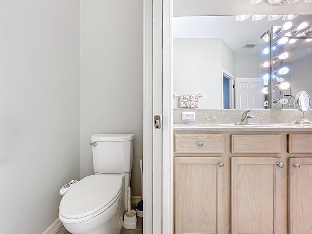 bathroom featuring vanity and toilet