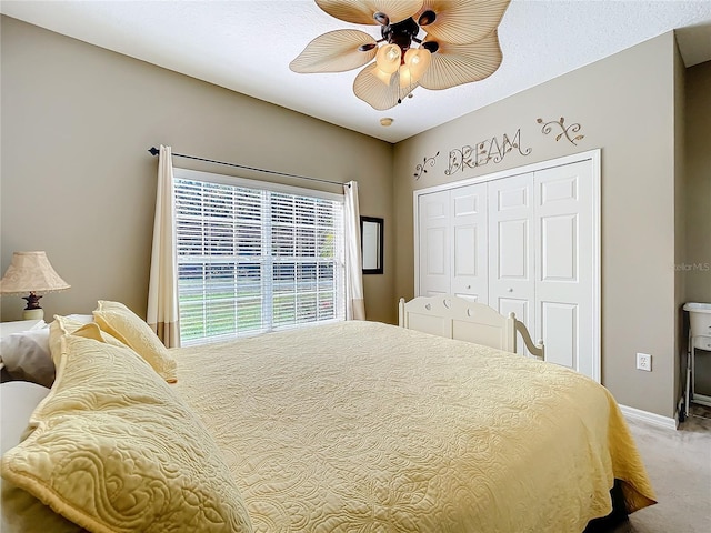 bedroom with ceiling fan, a closet, and carpet floors