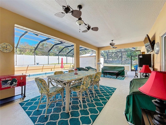 sunroom / solarium featuring ceiling fan and a pool