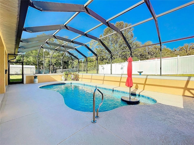 view of swimming pool with a lanai, a patio, and a shed