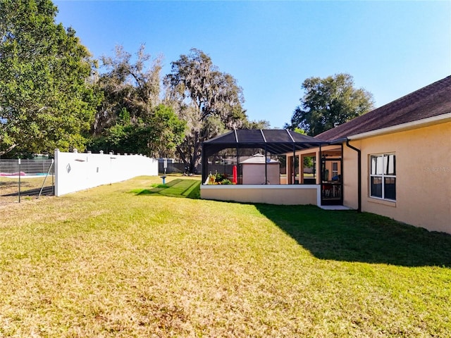 view of yard with glass enclosure