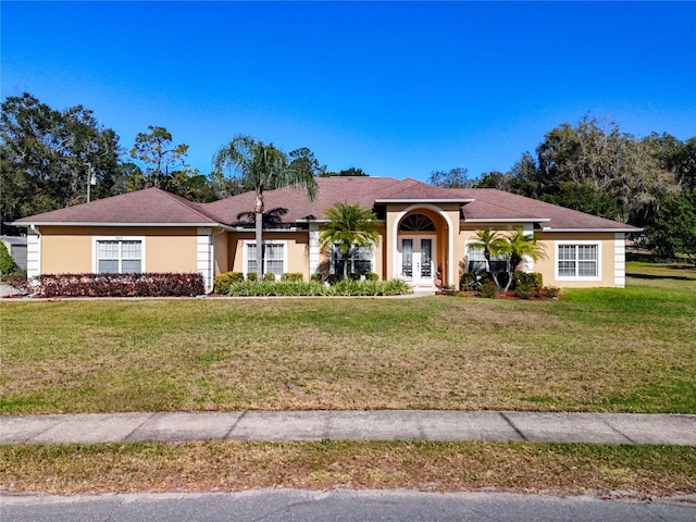 single story home with a front yard and french doors