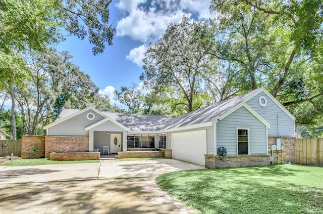 ranch-style house featuring a garage and a front lawn