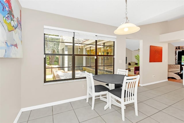 dining space with tile patterned flooring and lofted ceiling