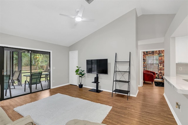 living room with ceiling fan, wood-type flooring, and high vaulted ceiling