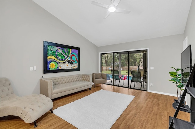 living room featuring ceiling fan, light hardwood / wood-style floors, and lofted ceiling