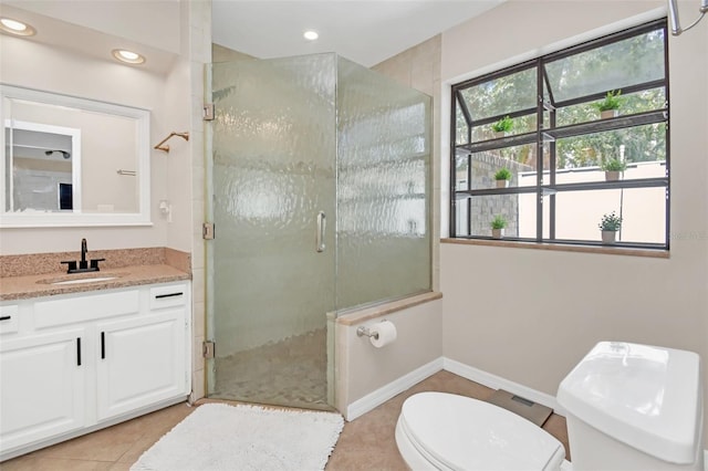 bathroom featuring vanity, a healthy amount of sunlight, an enclosed shower, and toilet