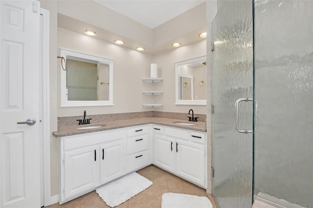 bathroom with tile patterned flooring, vanity, and an enclosed shower