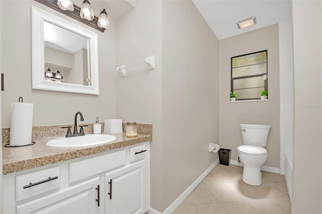 bathroom featuring tile patterned flooring, vanity, and toilet