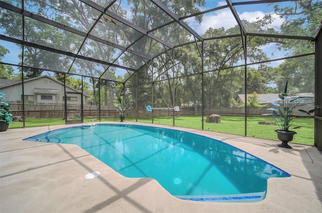 view of swimming pool with a lawn, glass enclosure, and a patio area