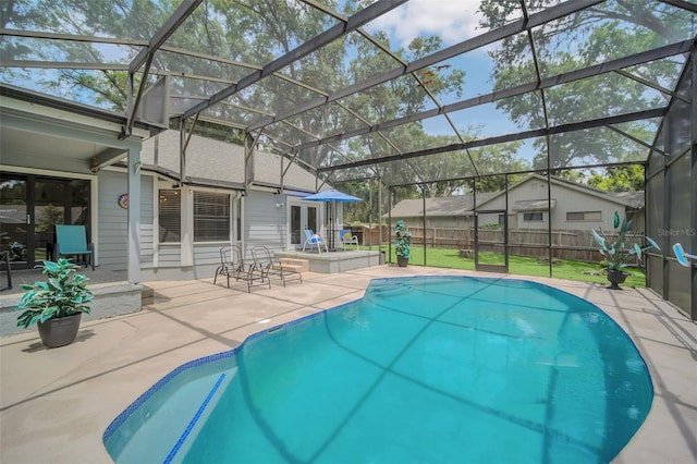 view of swimming pool with a lanai and a patio