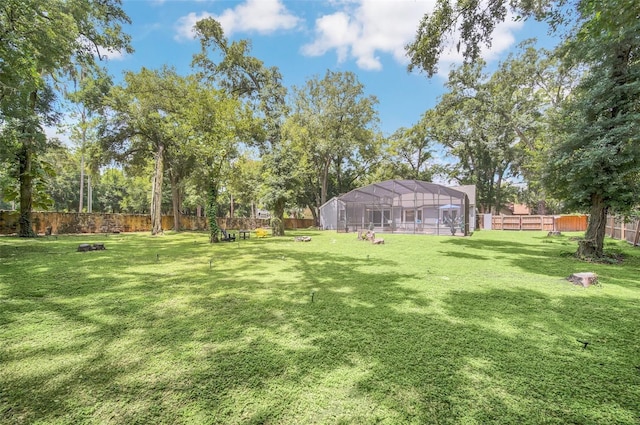 view of yard with glass enclosure