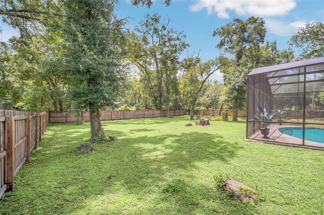 view of yard featuring a lanai and a fenced in pool