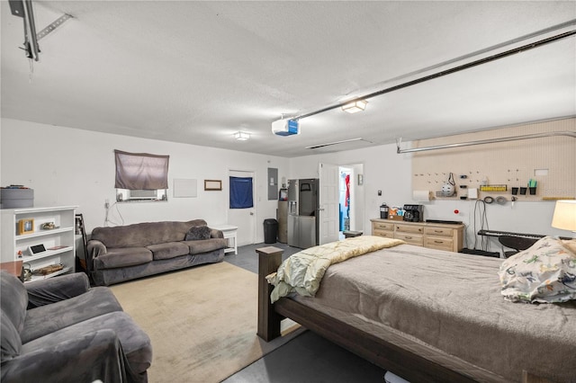 bedroom featuring a textured ceiling, electric panel, and concrete floors