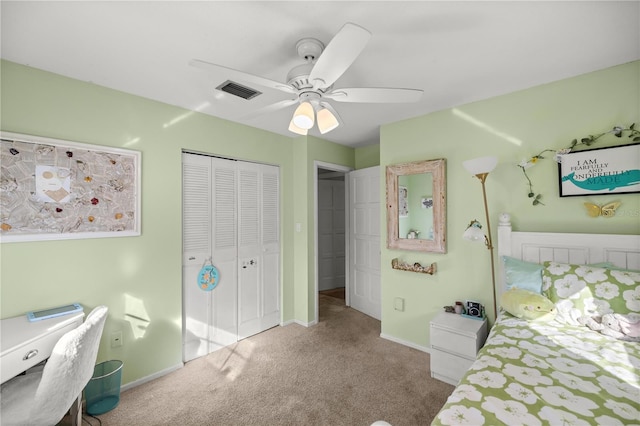 carpeted bedroom featuring ceiling fan and a closet