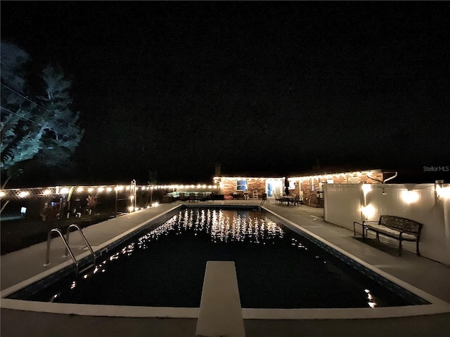 pool at night with a patio