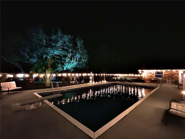 pool at twilight with a patio