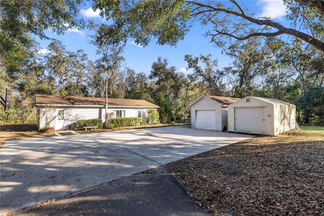 single story home featuring a detached garage and an outdoor structure