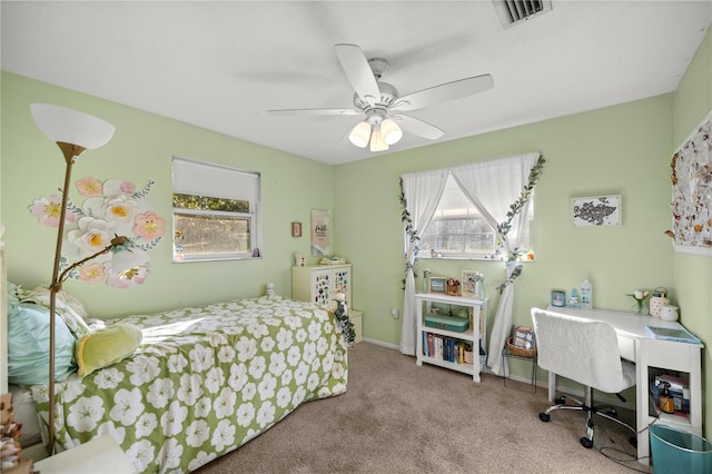 bedroom featuring ceiling fan, visible vents, baseboards, and light colored carpet