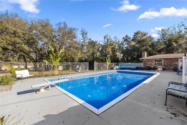 view of pool featuring a patio area, fence, a fenced in pool, and an outbuilding