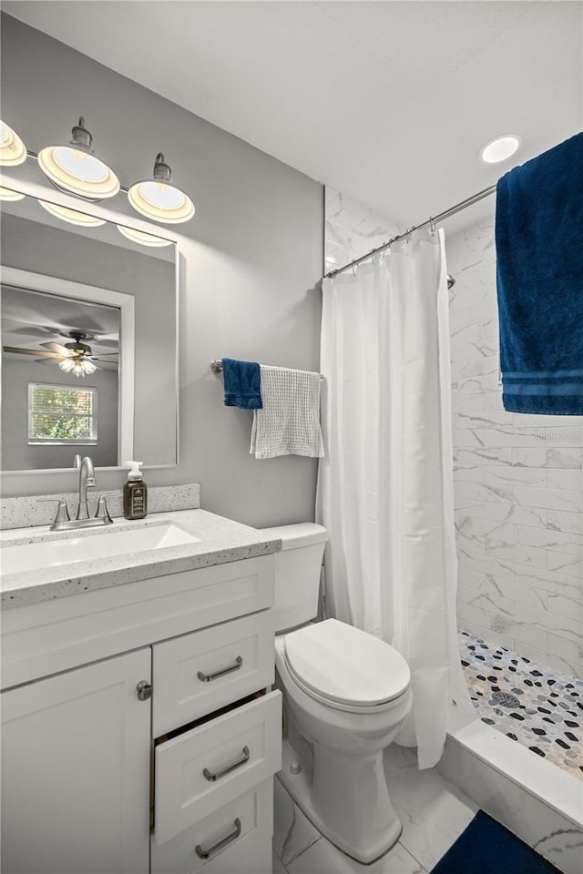 full bath with toilet, ceiling fan, marble finish floor, vanity, and a shower stall