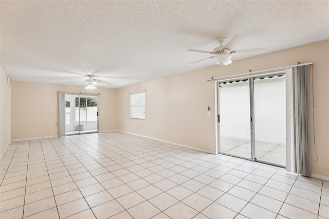 tiled spare room featuring a textured ceiling and ceiling fan