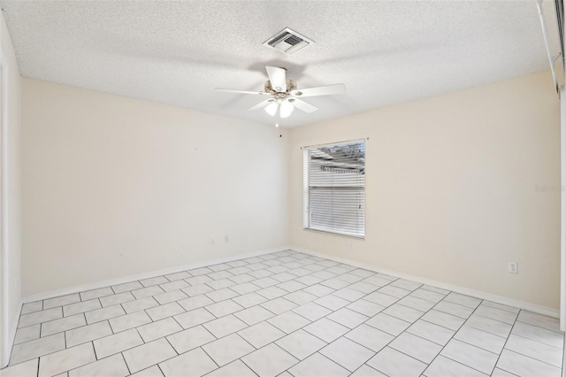 tiled empty room featuring a textured ceiling and ceiling fan