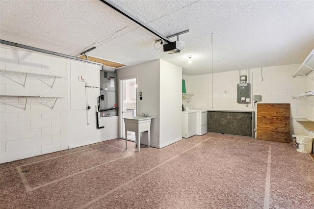 garage featuring separate washer and dryer, sink, a garage door opener, and electric panel