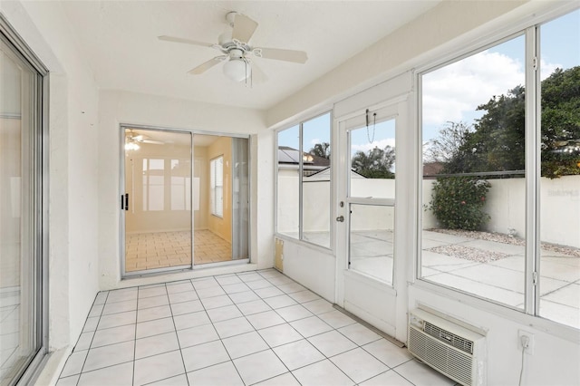 unfurnished sunroom with ceiling fan