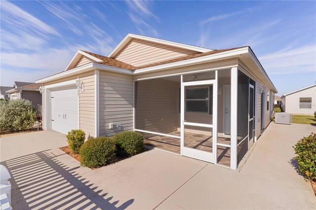 view of front of house with a sunroom and a garage