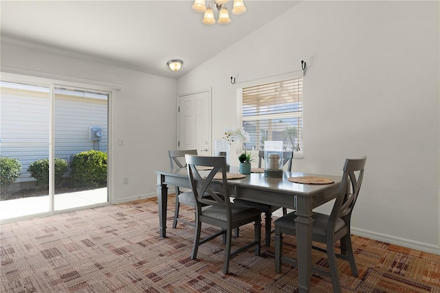 dining room featuring light carpet and vaulted ceiling