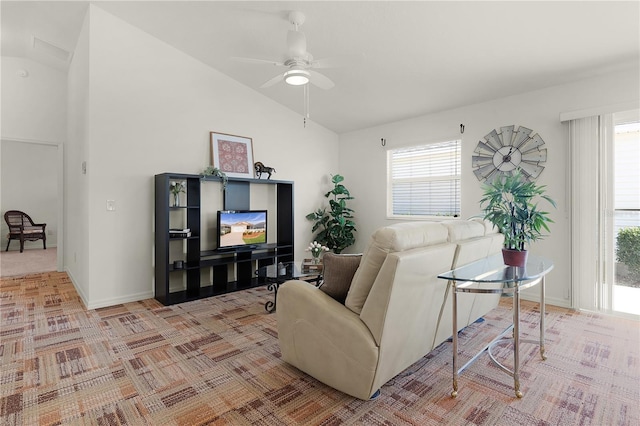 living room featuring ceiling fan, lofted ceiling, and a wealth of natural light