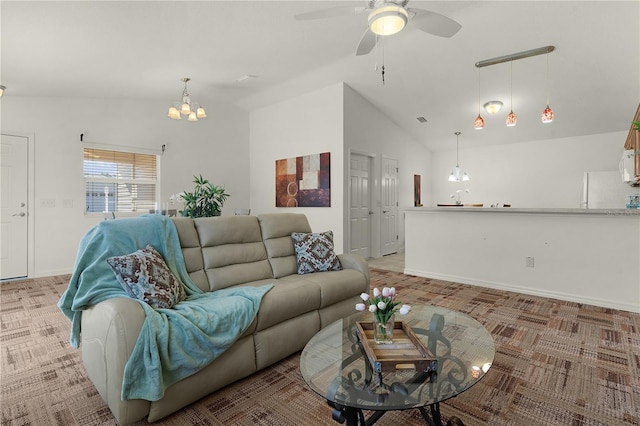 living room with ceiling fan with notable chandelier, light colored carpet, and lofted ceiling