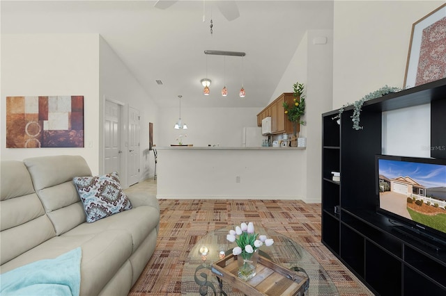 living room with ceiling fan and vaulted ceiling