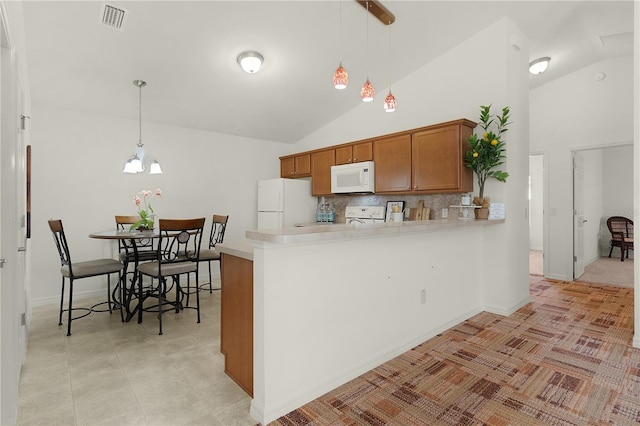 kitchen with kitchen peninsula, decorative backsplash, white appliances, and hanging light fixtures