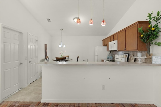 kitchen with white appliances, vaulted ceiling, decorative backsplash, decorative light fixtures, and kitchen peninsula