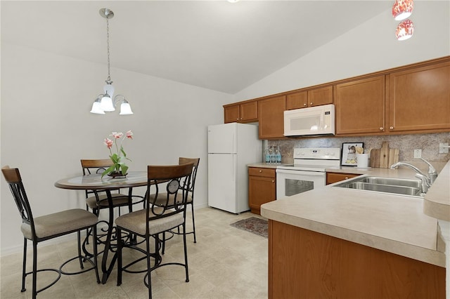 kitchen featuring sink, hanging light fixtures, backsplash, vaulted ceiling, and white appliances