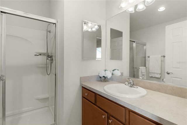 bathroom with vanity, toilet, and walk in shower