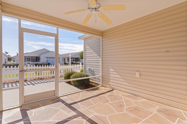 sunroom / solarium featuring ceiling fan