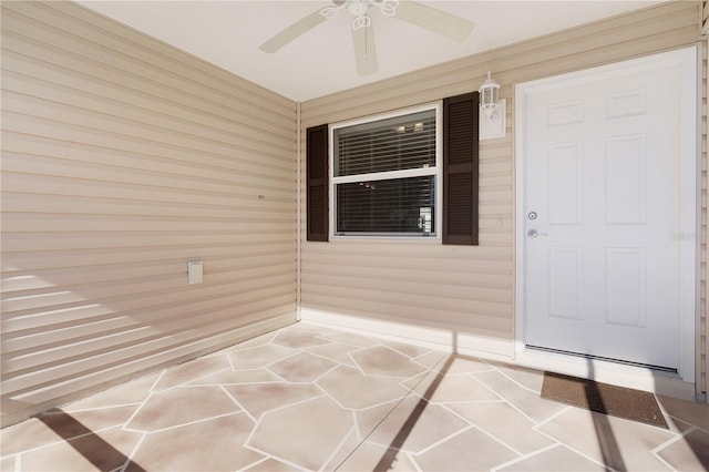 property entrance with ceiling fan and a porch