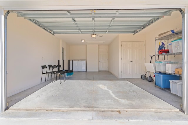 garage with washing machine and dryer and electric panel