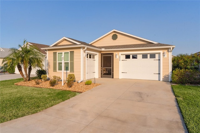 single story home featuring a garage and a front lawn