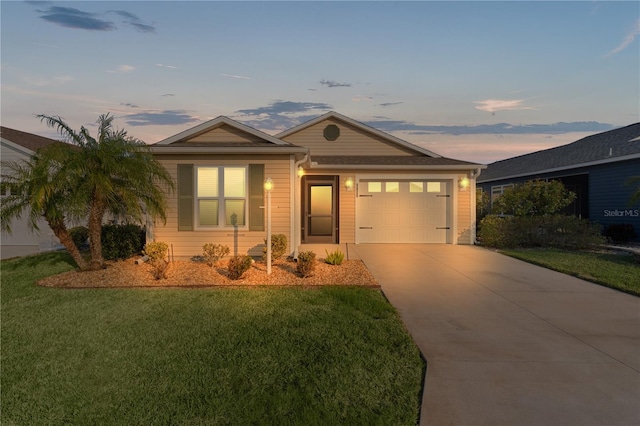 ranch-style home featuring a garage and a lawn