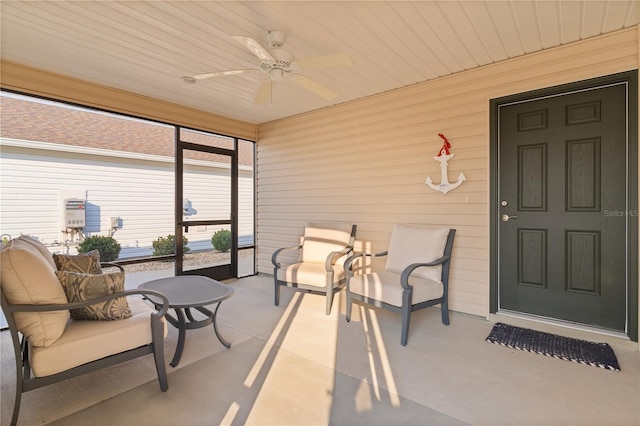 sunroom / solarium featuring ceiling fan