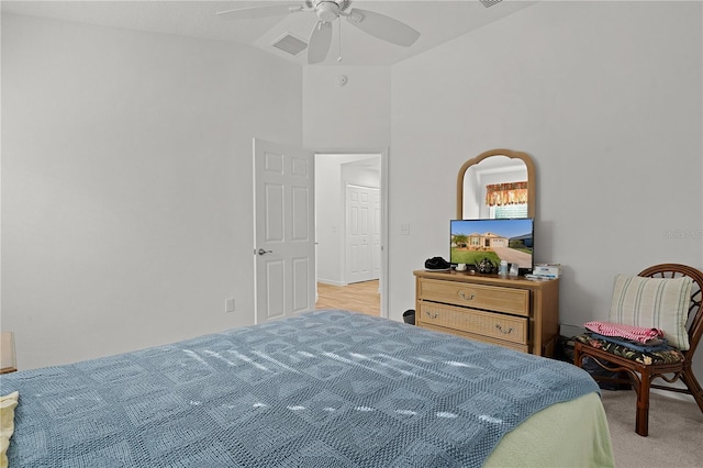 carpeted bedroom with ceiling fan and vaulted ceiling