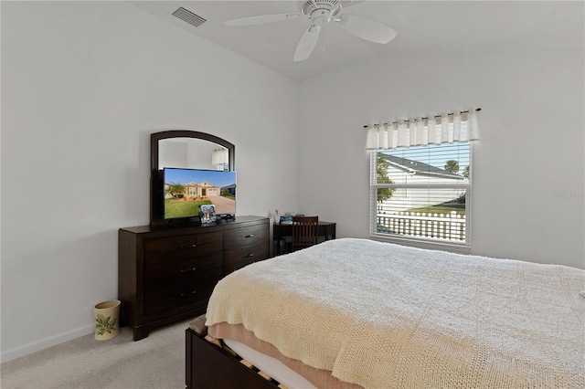 bedroom with light colored carpet, vaulted ceiling, and ceiling fan