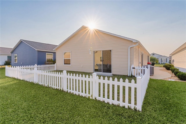 view of front of property with a yard and cooling unit