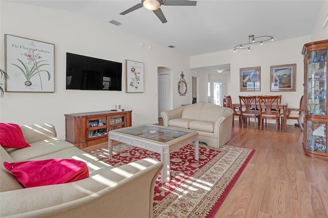 living room with ceiling fan and light hardwood / wood-style floors