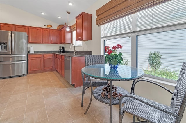 kitchen with sink, hanging light fixtures, stainless steel appliances, lofted ceiling, and light tile patterned flooring